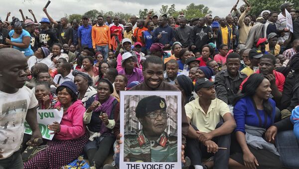 People gather to demonstrate for the ouster of 93-year-old President Robert Mugabe who is virtually powerless and deserted by most of his allies, in Harare, Zimbabwe, Saturday, Nov. 18, 2017 - Sputnik International