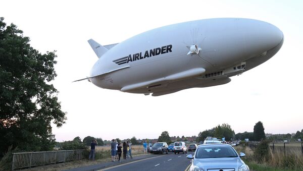 The Hybrid Air Vehicles HAV 304 Airlander 10 hybrid airship is seen in the air over a road on its maiden flight from Cardington Airfield near Bedford, north of London, on August 17, 2016 - Sputnik International