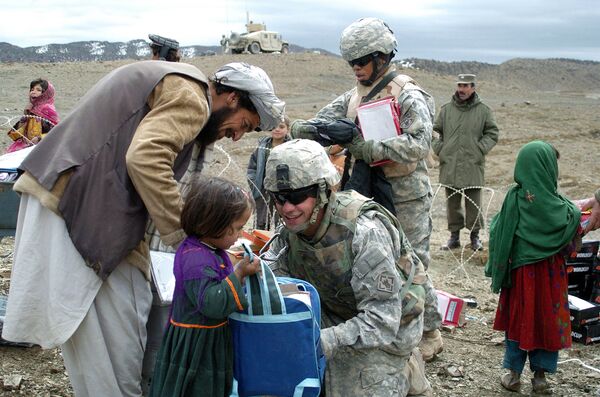 In this US Miltary Handout picture taken, 16 March 2007, U.S soldiers with the NATO-led International Security Assistance Force (ISAF) distribute school stationery to Afghan children in Orgun in eastern Afghanistan - Sputnik International