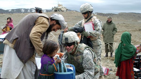 In this US Miltary Handout picture taken, 16 March 2007, U.S soldiers with the NATO-led International Security Assistance Force (ISAF) distribute school stationery to Afghan children in Orgun in eastern Afghanistan - Sputnik International