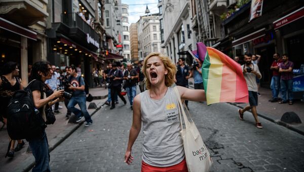 A LGBT member waves a rainbow flag during a rally staged by the LGBT community on Istiklal avenue in Istanbul on June 26, 2016 - Sputnik International