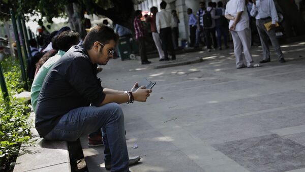 An Indian man uses his mobile phone in New Delhi, India. (File) - Sputnik International