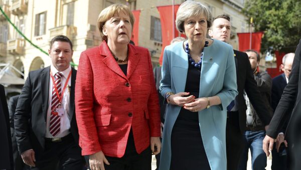 German Chancellor Angela Merkel, left, speaks with British Prime Minister Theresa May, right, as they walk with other EU leaders during an event at an EU summit in Valletta, Malta, on Friday, Feb. 3, 2017. - Sputnik International