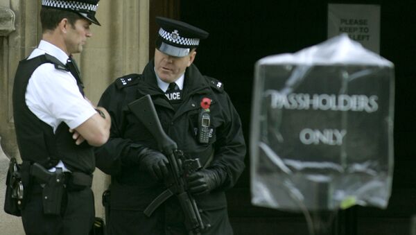 Armed police stand outside an entrance to the Palace of Westminster, in London. - Sputnik International