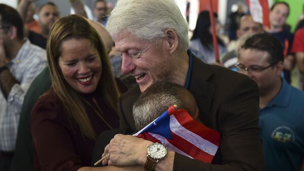 Former President Bill Clinton hugs a resident living at the William Rivera Betancourt Vocational School which was turned into an emergency shelter for families affected by the impact of Hurricane Maria, in Canovanas, Puerto Rico, Monday, Nov. 20, 2017 - Sputnik International