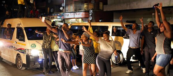 Zimbabweans living in South Africa celebrate after President Robert Mugabe resigns, in Johannesburg, South Africa November 21, 2017 Zimbabweans living in South Africa celebrate after President Robert Mugabe resigns, in Johannesburg, South Africa November 21, 2017 - Sputnik International