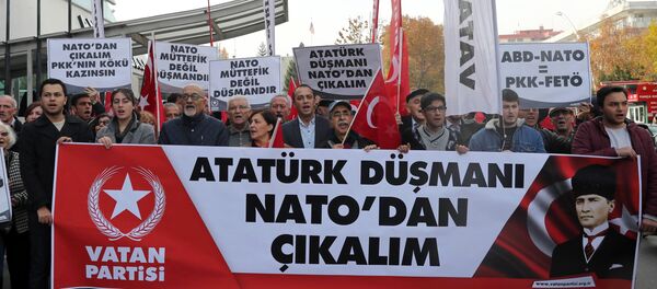 Protestors wave flags and carry a banner during a demonstration against NATO military exercises on November 18, 2017 in Ankara Protestors wave flags and carry a banner during a demonstration against NATO military exercises on November 18, 2017 in Ankara - Sputnik International