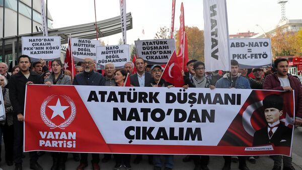 Protestors wave flags and carry a banner during a demonstration against NATO military exercises on November 18, 2017 in Ankara - Sputnik International