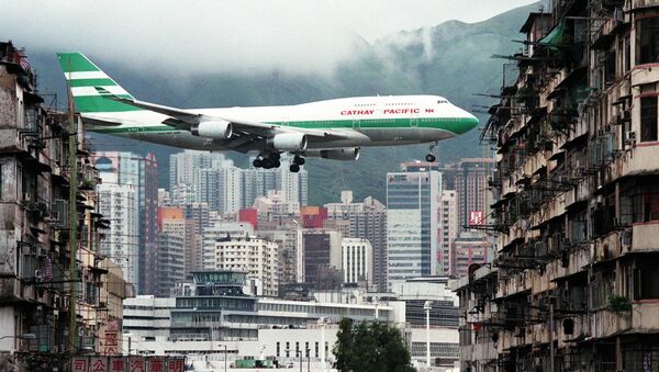 Hong Kong flag carrier Cathay Pacific, Boeing 747-400 jumbo jet, flies over the Kai Tak Airport control tower bottom as it approaches the Runway 13 on the last day of the 73-year-old airport - Sputnik International
