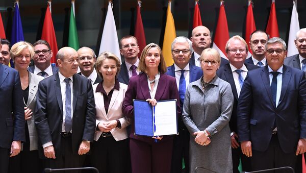 European Union foreign policy chief Federica Mogherini, center, poses with EU foreign and defense ministers after signing the notification on Permanent Structure Cooperation (PESCO) on the margin of a foreign affairs council at the Europa building in Brussels - Sputnik International