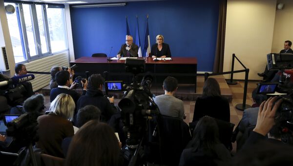 French far-right Front National (FN) party president Marine Le Pen (R), flanked by FN party member Wallerand de Saint-Just (L), speaks during a press conference focused on French democracy threatened by financial oligarchies, on November 22, 2017, in Paris - Sputnik International