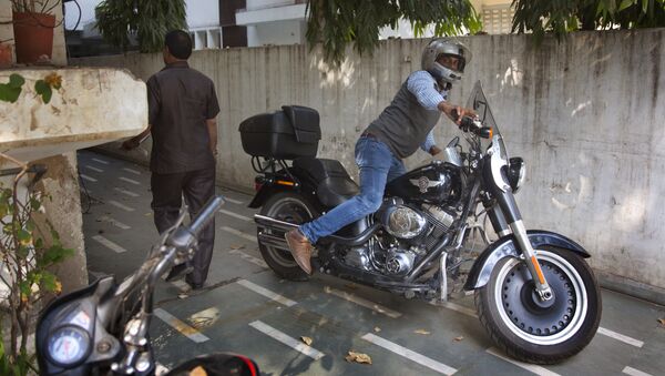 An Indian man parks his Harley Davidson Fat Boy motorcycle in New Delhi, India, Wednesday, March 1, 2017 - Sputnik International
