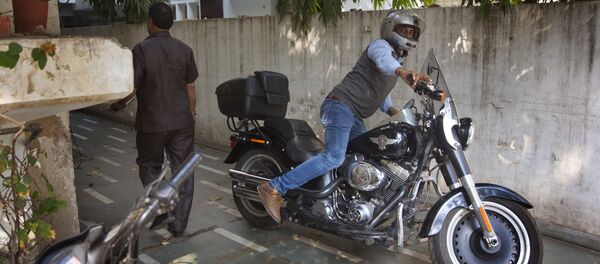 An Indian man parks his Harley Davidson Fat Boy motorcycle in New Delhi, India, Wednesday, March 1, 2017 An Indian man parks his Harley Davidson Fat Boy motorcycle in New Delhi, India, Wednesday, March 1, 2017 - Sputnik International