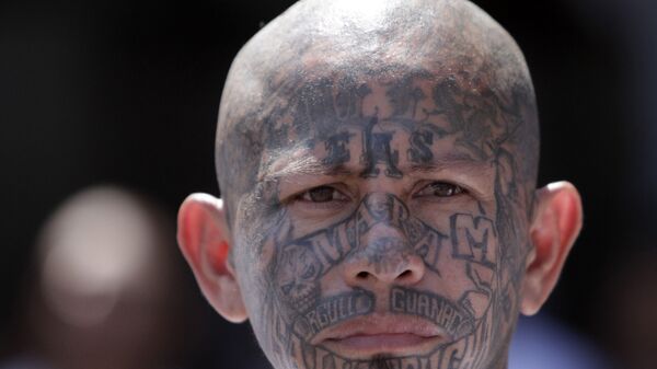 In this March 26, 2012 photo, an inmate belonging to the Mara Salvatrucha or MS-13 gang stands inside the prison in Ciudad Barrios, El Salvador. Six months after El Salvador brokered an historic truce between two rival gangs to curb the nation's daunting homicide rate, officials are split over whether the truce actually works. The gangs, which also operate in Guatemala and Honduras, are seeking truce talks in those countries as well.  - Sputnik International