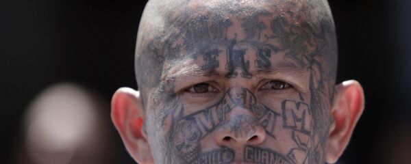 In this March 26, 2012 photo, an inmate belonging to the Mara Salvatrucha or MS-13 gang stands inside the prison in Ciudad Barrios, El Salvador. Six months after El Salvador brokered an historic truce between two rival gangs to curb the nation's daunting homicide rate, officials are split over whether the truce actually works. The gangs, which also operate in Guatemala and Honduras, are seeking truce talks in those countries as well. - Sputnik International
