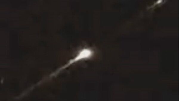 Mysterious fireball with burning sparks falling off spotted blazing across sky leaving eyewitne - Sputnik International