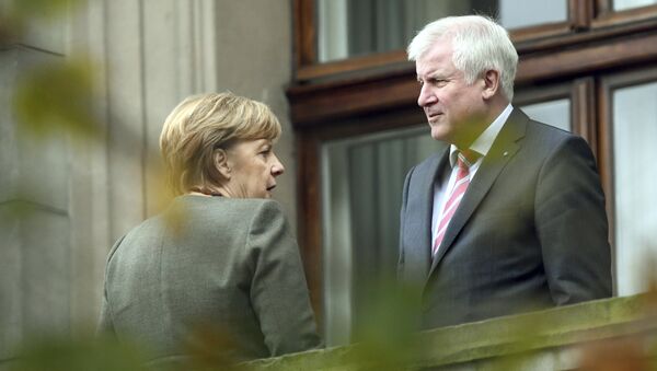 Chancellor Angela Merkel, left, talks to Bavarian governor Horst Seehofer during talks on forming a new government in Berlin Thursday, Oct. 26 2017 - Sputnik International
