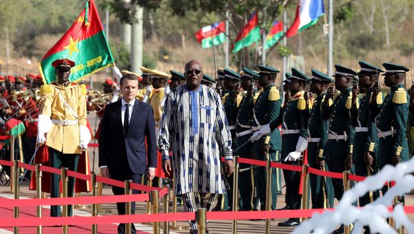 Burkina Faso's President Roch Marc Christian Kabore and French President Emmanuel Macron review troops during a welcoming ceremony at the Presidential Palace in Ouagadougou, Burkina Faso - Sputnik International