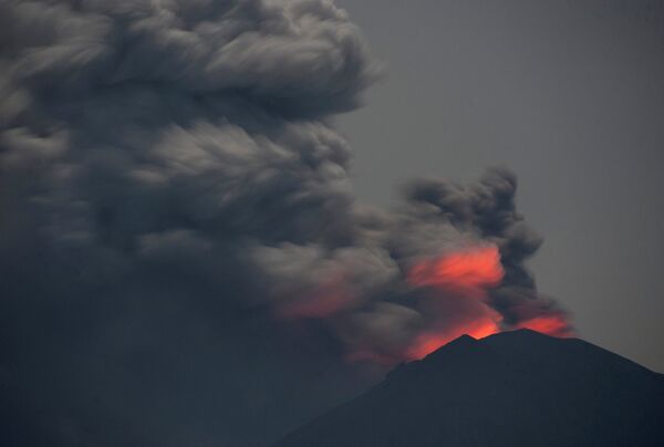 Light from lava inside the crater is reflected off volcanic ash from Mount Agung, as seen from Jemeluk Beach, Karangasem, Bali, Indonesia November 28, 2017 in this photo taken by Antara Foto. Picture taken November 28, 2017 - Sputnik International