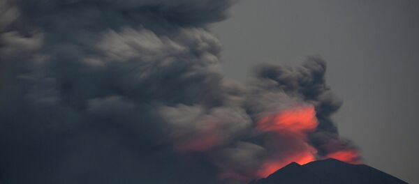 Light from lava inside the crater is reflected off volcanic ash from Mount Agung, as seen from Jemeluk Beach, Karangasem, Bali, Indonesia November 28, 2017 in this photo taken by Antara Foto. Picture taken November 28, 2017 - Sputnik International