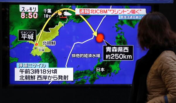 A woman walks past a street monitor showing a news report about North Korea's missile launch, in Tokyo, Japan, November 29, 2017 A woman walks past a street monitor showing a news report about North Korea's missile launch, in Tokyo, Japan, November 29, 2017 - Sputnik International