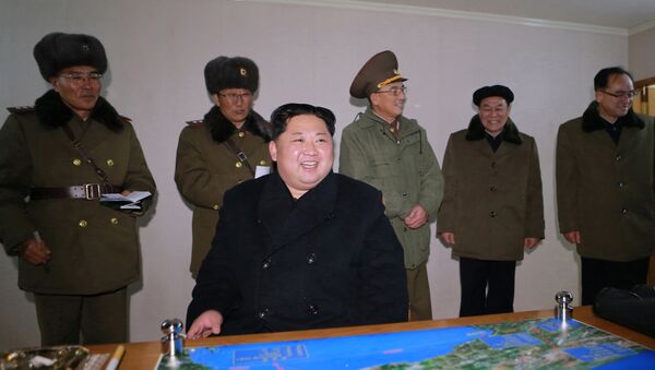 North Korea's leader Kim Jong Un is seen as the newly developed intercontinental ballistic rocket Hwasong-15's test was successfully launched, in this undated photo released by North Korea's Korean Central News Agency (KCNA) in Pyongyang November 30, 2017 - Sputnik International