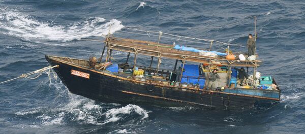 A wooden boat carrying men identified as North Koreans by coast guards drifts off Matsumae town, on Japanese northern island of Hokkaido, in this photo taken by Kyodo November 29, 2017. Picture taken November 29, 2017 A wooden boat carrying men identified as North Koreans by coast guards drifts off Matsumae town, on Japanese northern island of Hokkaido, in this photo taken by Kyodo November 29, 2017. Picture taken November 29, 2017 - Sputnik International