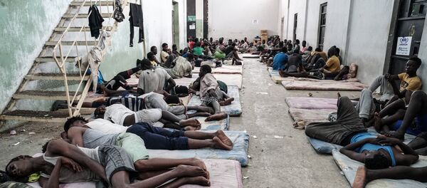 Illegal immigrants are seen at a detention centre in Zawiyah, 45 kilometres west of the Libyan capital Tripoli, on June 17, 2017 - Sputnik International
