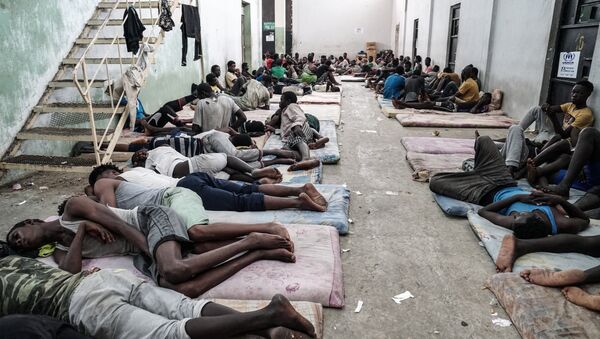 Illegal immigrants are seen at a detention centre in Zawiyah, 45 kilometres west of the Libyan capital Tripoli, on June 17, 2017 - Sputnik International
