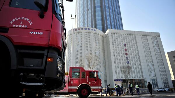 Fire trucks are seen outside a skyscraper after a fire broke out around 4 a.m. on the 38th floor of a serviced apartment, in Tianjin, China December 1, 2017 - Sputnik International
