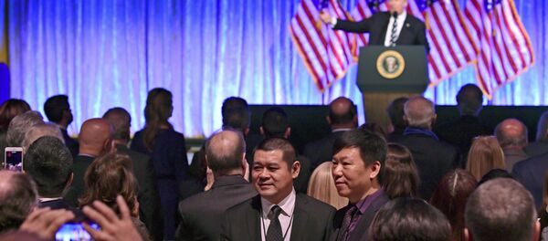 People in the audience have their photo taken as President Donald Trump speaks at a fundraiser People in the audience have their photo taken as President Donald Trump speaks at a fundraiser - Sputnik International