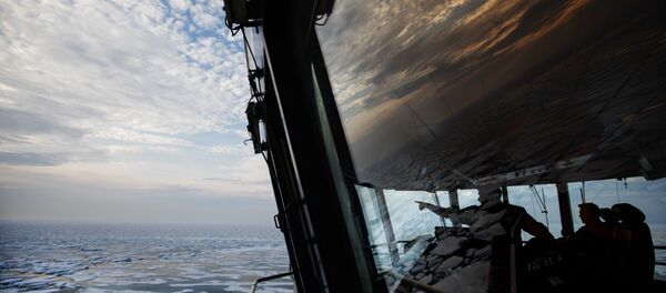 Nigel Greenwood, assistant ice navigator, left, talks with second officer Ilkka Alhoke on the bridge of the Finnish icebreaker MSV Nordica as they sail through sea ice while traversing the Northwest Passage in the Canadian Arctic Archipelago, Saturday, July 22, 2017. - Sputnik International