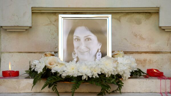Flowers and tributes lay at the foot of the Great Siege monument in Valletta, Malta, on October 19, 2017 which has been turned into a temporary shrine for Maltese journalist and blogger Daphne Caruana Galizia (picture) who was killed by a car bomb outside her home in Bidnjia, Malta, on October 16, 2017 - Sputnik International