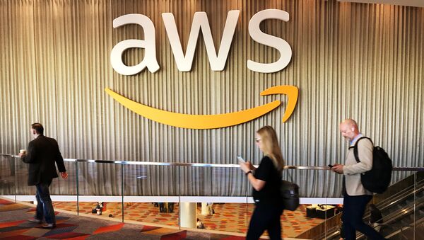 Attendees at Amazon.com Inc annual cloud computing conference walk past the Amazon Web Services logo in Las Vegas, Nevada, U.S., November 30, 2017 - Sputnik International
