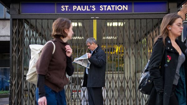 (File) A man stands outside the locked gates of St Paul's underground station in central London, on November 3, 2010 - Sputnik International