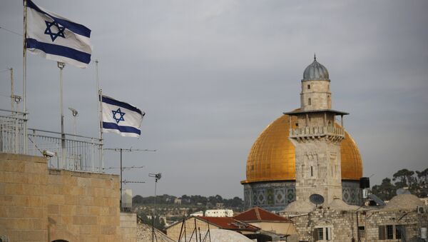 Israeli flags fly near the Dome of the Rock in the Al-Aqsa mosque compound - Sputnik International