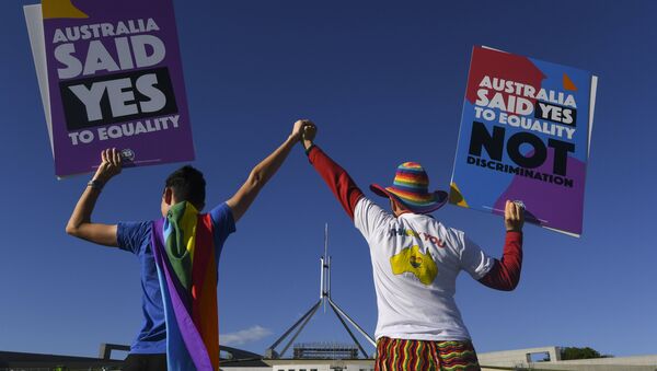 Same-sex marriage campaigners pose for pictures during an equality rally outside Parliament House in Canberra December 7, 2017 - Sputnik International