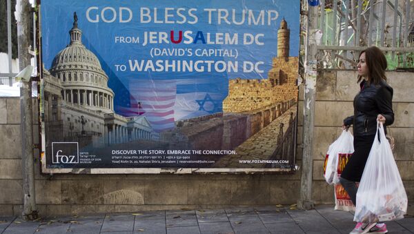 A woman walks past a poster praising U.S. President Donald Trump’s recognition of Jerusalem as Israel’s capital, in Jerusalem, Thursday, Dec. 7, 2017 - Sputnik International