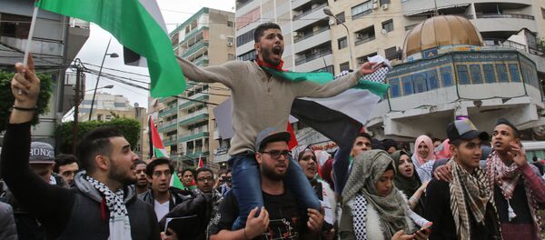 Palestinian students waving the national Palestinian flag and a model of Jerusalem's Dome of the Rock mosque protest in the streets of the southern Lebanese port city of Sidon on December 7, 2017 against US President Donald Trump's recognition of Jerusalem as Israel's capital Palestinian students waving the national Palestinian flag and a model of Jerusalem's Dome of the Rock mosque protest in the streets of the southern Lebanese port city of Sidon on December 7, 2017 against US President Donald Trump's recognition of Jerusalem as Israel's capital - Sputnik International