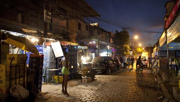 In this photo taken May 25, 2011, A sex worker waits for customers at the Vila Mimosa prostitution zone in Rio de Janeiro, Brazil - Sputnik International