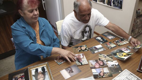In this Aug. 15, 2016 photo, Gordon Davis and his wife Thelma look through photos of their daughter, Lynette Daley, at their home in Yamba, Australia. The brutal death of Daley, an Aboriginal woman, and the reluctance of officials to prosecute the white suspects, has highlighted a deadly racial divide in Australia, where Indigenous people remain the most disadvantaged segment of society - Sputnik International