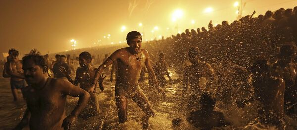 In this Jan. 14, 2013 file photo, an Indian Hindu man jumps up and down in the water as he takes a dip at Sangam, the confluence of the Ganges, Yamuna and mythical Saraswati River, during the royal bath on Makar Sankranti at the start of the Maha Kumbh Mela in Allahabad, India In this Jan. 14, 2013 file photo, an Indian Hindu man jumps up and down in the water as he takes a dip at Sangam, the confluence of the Ganges, Yamuna and mythical Saraswati River, during the royal bath on Makar Sankranti at the start of the Maha Kumbh Mela in Allahabad, India - Sputnik International