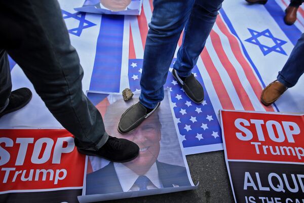 Palestinian protesters step on US and Israeli flags and on a portrait of US President Donald Trump following his decision to recognise Jerusalem as the capital of Israel, in Gaza City Palestinian protesters step on US and Israeli flags and on a portrait of US President Donald Trump following his decision to recognise Jerusalem as the capital of Israel, in Gaza City - Sputnik International