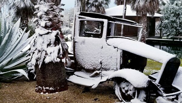 The remains of an old lorry covered with snow are pictured in Santa Fe, Texas, U.S., December 8, 2017 in this picture obtained from social media - Sputnik International