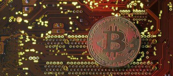 A copy of bitcoin standing on PC motherboard is seen in this illustration picture, October 26, 2017 - Sputnik International