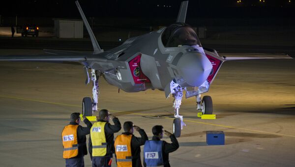 Israeli air force officers salute toward one of the first two next-generation F-35 fighter jets during an unveiling ceremony after it landed in Nevatim Air Force base near Beersheba, Southern Israel, Monday, Dec. 12, 2016 - Sputnik International