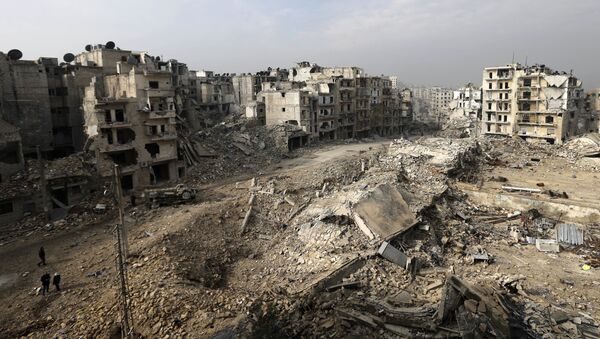 In this picture taken Friday, Jan. 20, 2017 from the balcony of the Abdul-Hamid Khatib home, people walk through mounds of rubble which used to be high rise apartment buildings in the once rebel-held Ansari neighborhood in the eastern Aleppo, Syria - Sputnik International