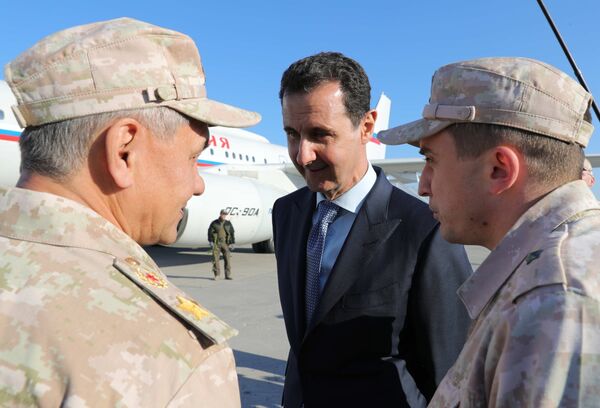 President of the Syrian Arab Republic Bashar Assad and Russian Defense Minister Sergei Shoigu (left) during the meeting with Russian President Vladimir Putin at the Hmeymim airbase in Syria on December 11, 2017. President of the Syrian Arab Republic Bashar Assad and Russian Defense Minister Sergei Shoigu (left) during the meeting with Russian President Vladimir Putin at the Hmeymim airbase in Syria on December 11, 2017. - Sputnik International