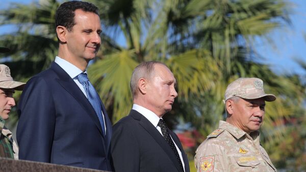 President of Russia Vladimir Putin, President of Syria Bashar al-Assad (left) and Defense Minister Sergei Shoigu at the Hmeymim Air Base in Syria - Sputnik International