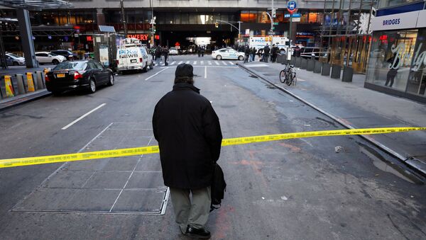 A passer-by looks over the police tape outside the New York Port Authority Bus Terminal in New York City, U.S. December 11, 2017 after reports of an explosion - Sputnik International